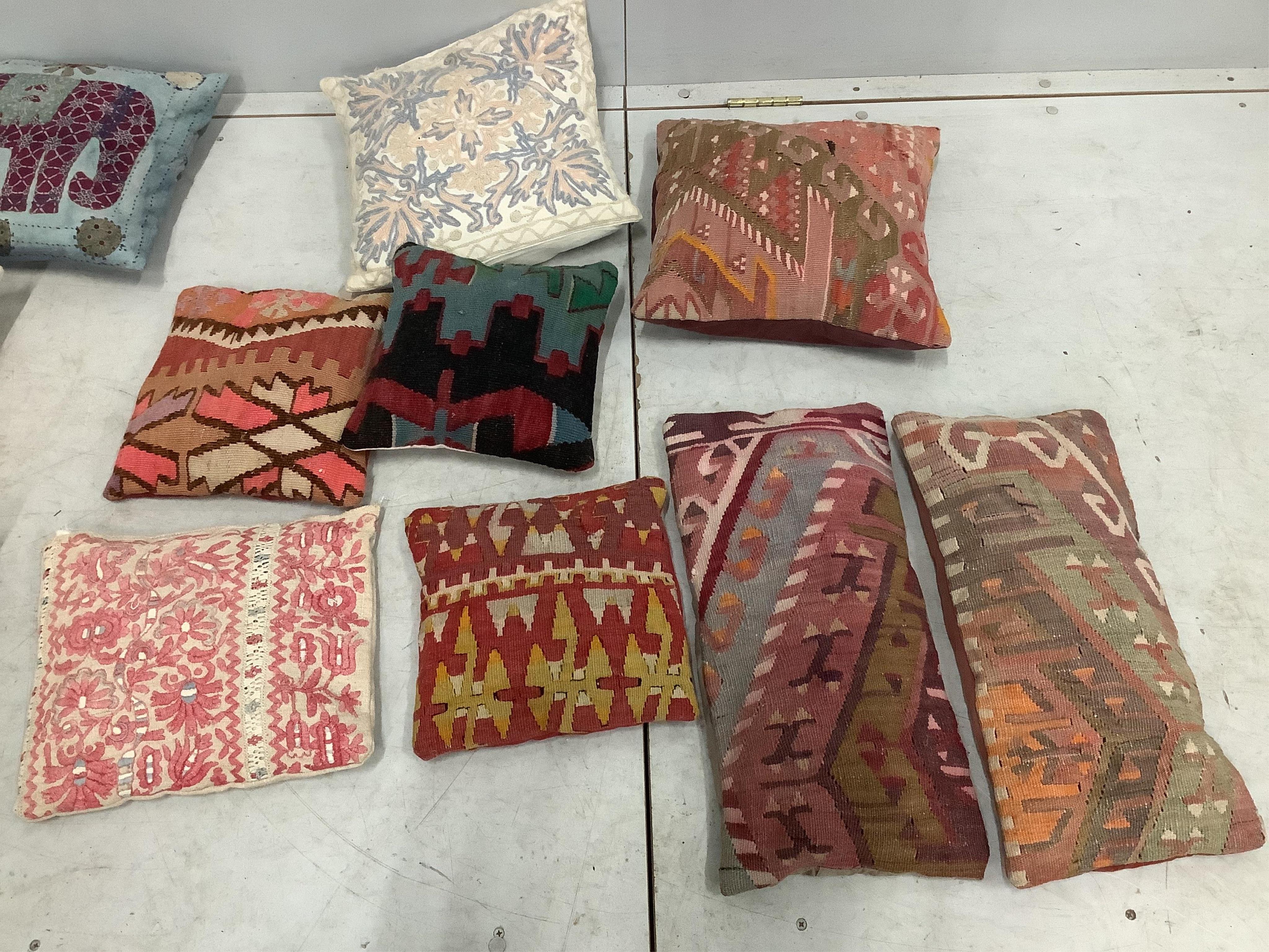 A collection of sixteen Kilim and other embroidered cushions, largest 38 x 35cm. Condition - fair